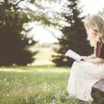 Girl reading book in garden